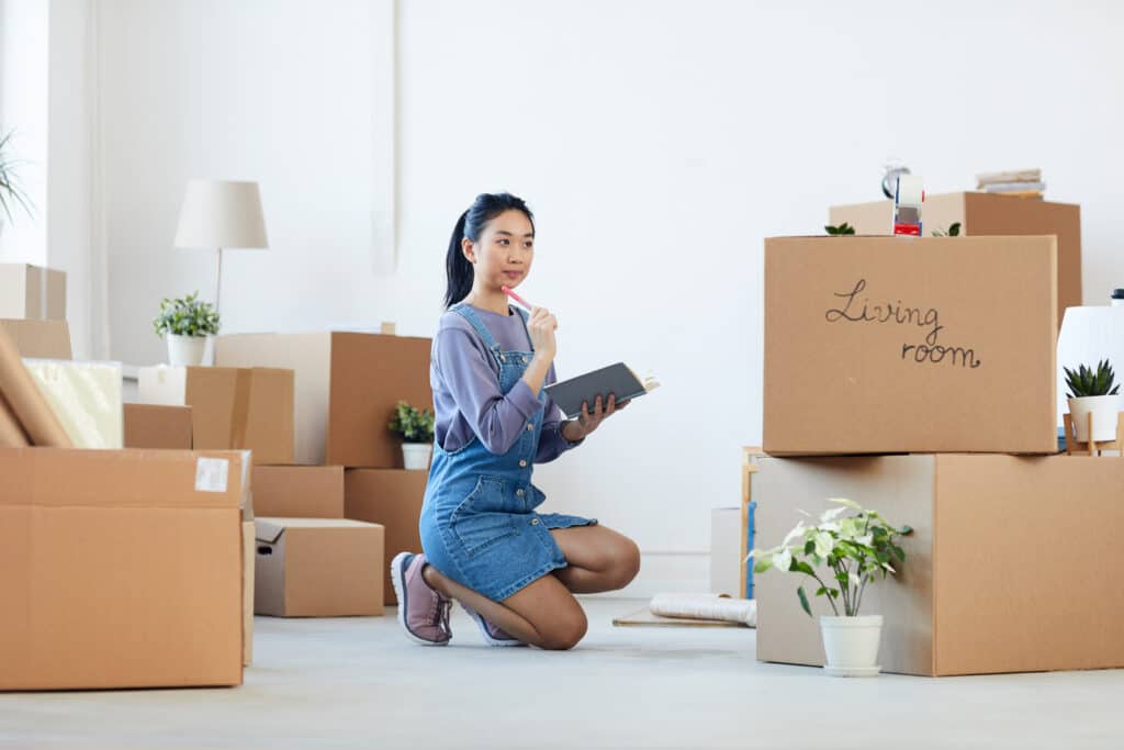 woman looking for ways to organize her room with boxes
